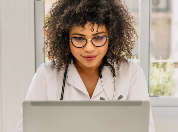 smiling-afro-female-doctor-using-laptop-at-medical-2023-11-27-04-49-41-utc 1 (1)